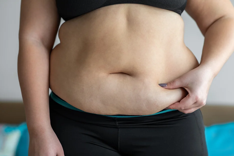 A Woman Pinchin Her Belly Fat