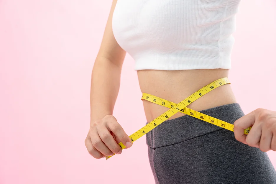 A woman measuring her stomach