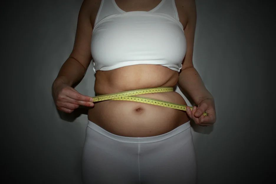 A Woman Measuring Her Fatty Stomach