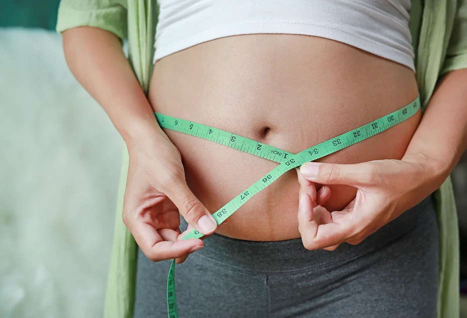 A Woman Measuring Her Stomach